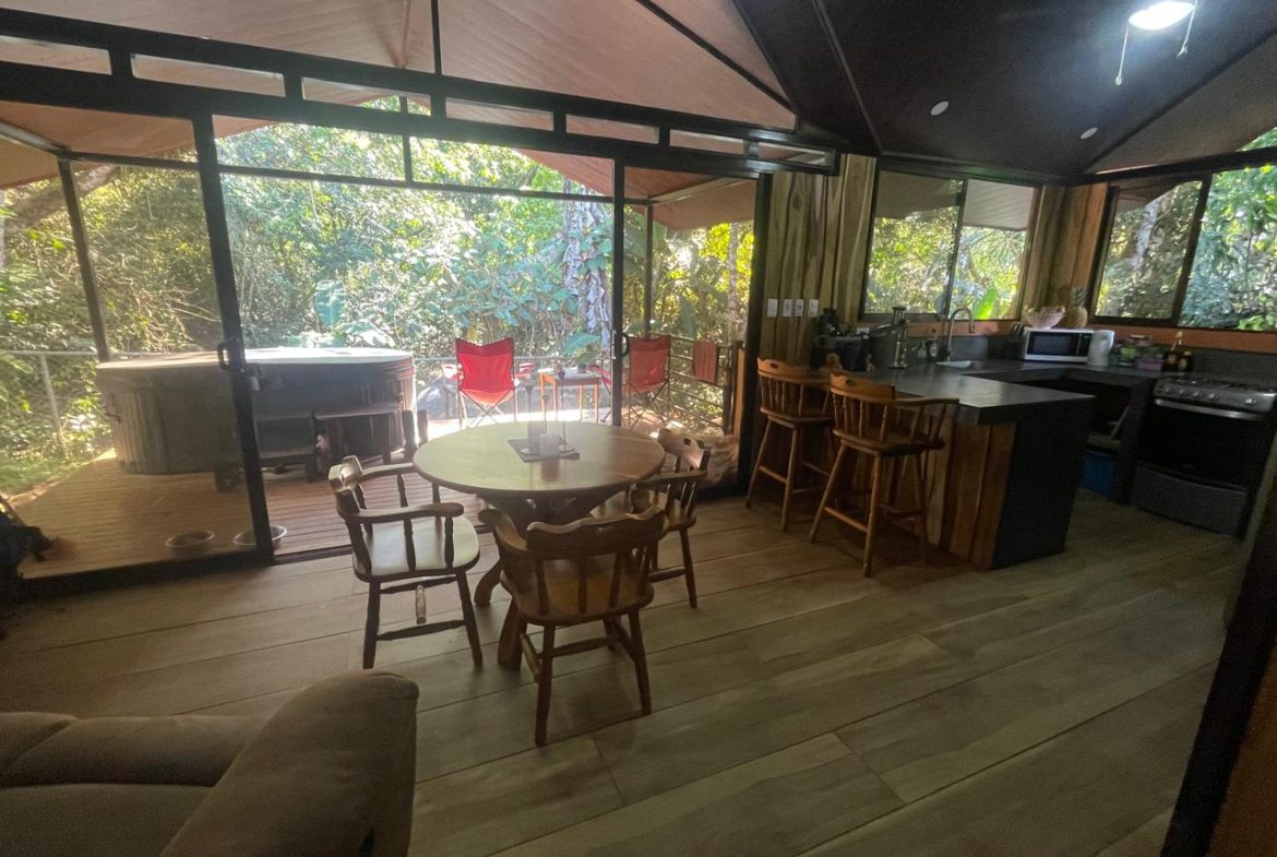 PRIVATE RIVERFRONT ESTATE WITH MAIN HOME, GUEST CABIN AND LUSH GROUNDS ON 0.68-ACRE
