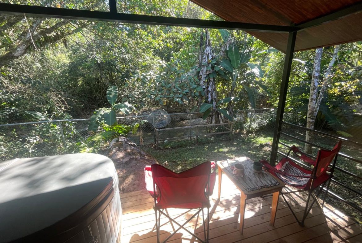 PRIVATE RIVERFRONT ESTATE WITH MAIN HOME, GUEST CABIN AND LUSH GROUNDS ON 0.68-ACRE