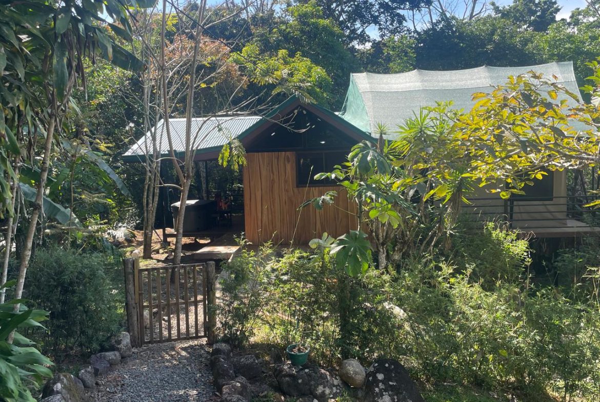 PRIVATE RIVERFRONT ESTATE WITH MAIN HOME, GUEST CABIN AND LUSH GROUNDS ON 0.68-ACRE